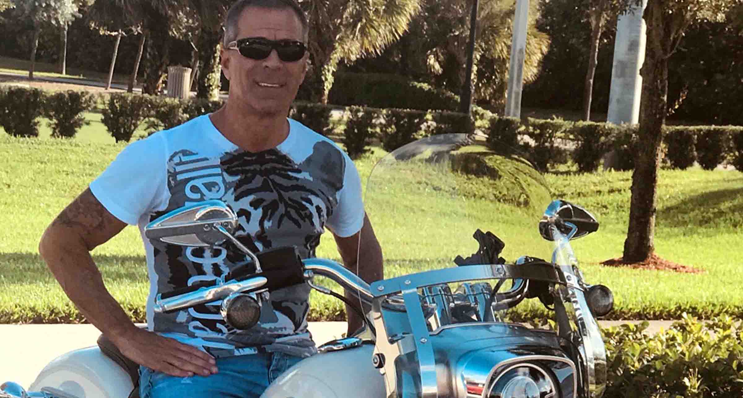 Patient Ron sitting on a motorcycle.