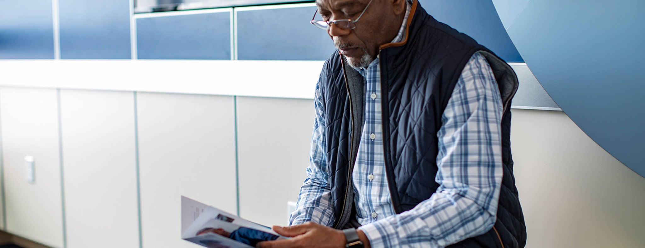 Older man looking at a brochure.