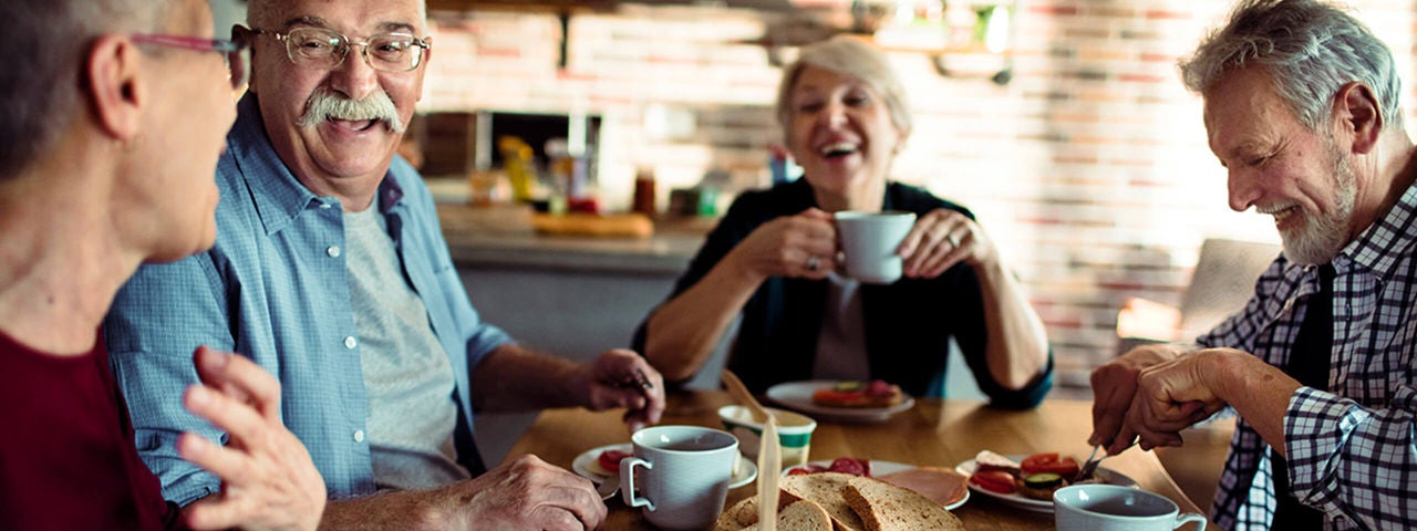 Group of adults eating together.